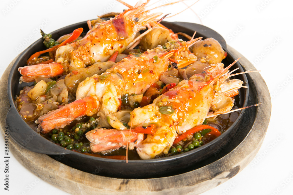 big prawns top with hot and spicy sauce serve in hot plate
