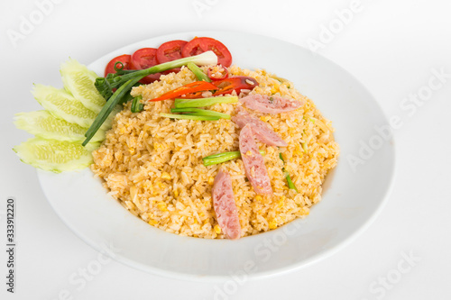 thai fired rice with fermented pork eat with cucumber tomato and spring onion serve in white plate