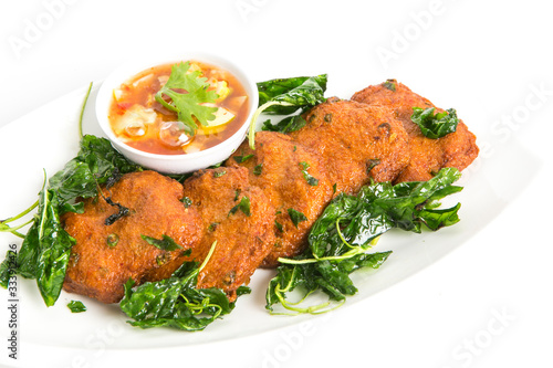 deep fried fish cake serve with fried basil leaves eat with sweet cucumber sauce