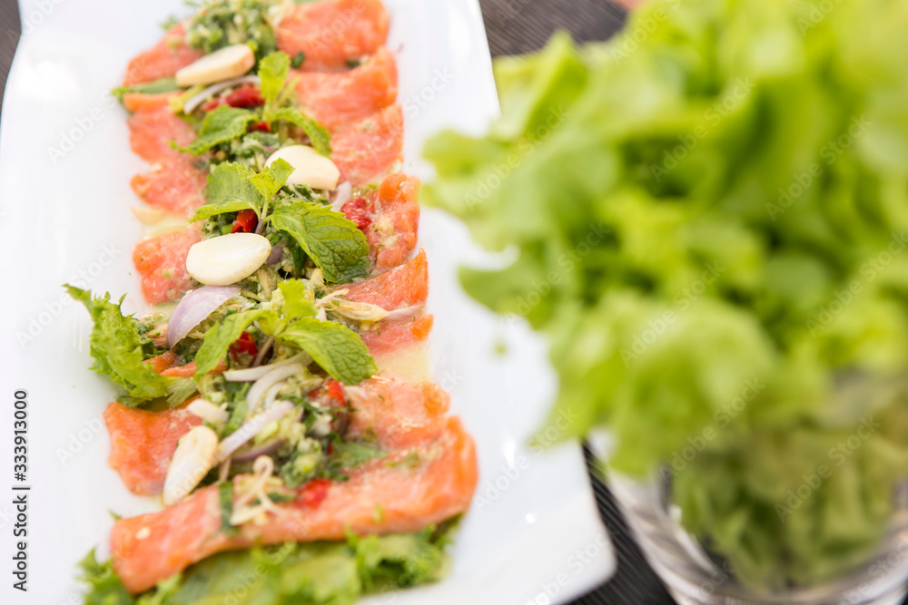 fresh raw salmon tip with spicy thai sauce eat with vegetable
