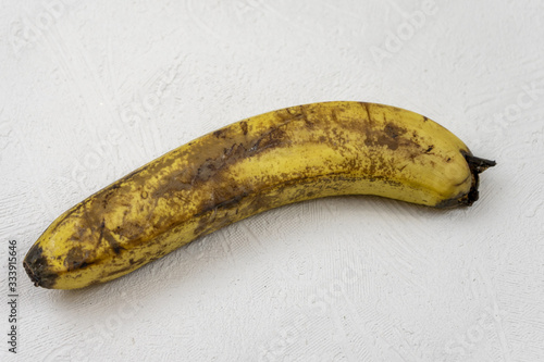 Old spoiled banana on a white background