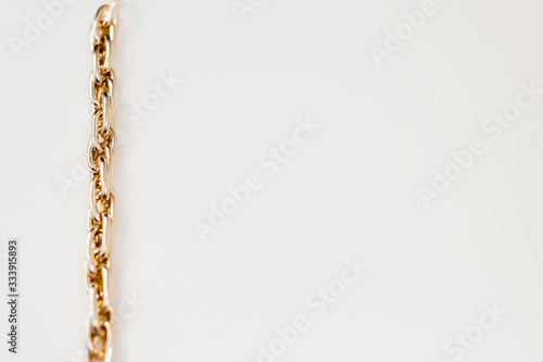 massive golden braided chain bracelet on a white background in isolation copy space place text