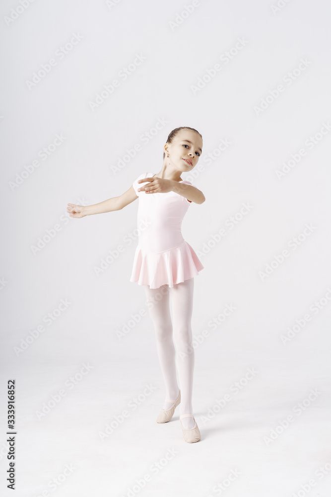 Adorable pre-teen ballerina dancing on white background Adorable pre-teen ballerina dancing on white background