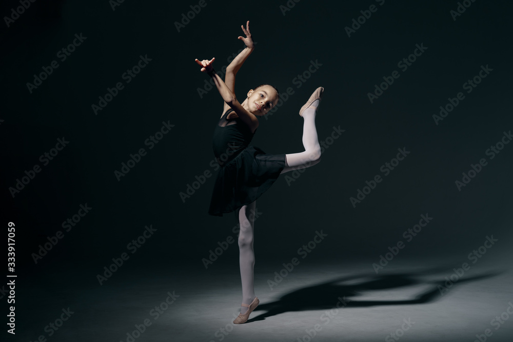 Delicate girl ballerina dancing in studio