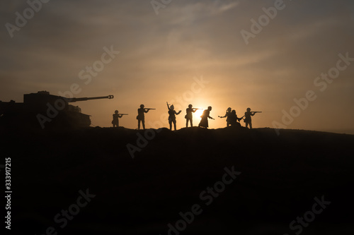 War Concept. Military silhouettes fighting scene on war fog sky background  World War Soldiers Silhouette Below Cloudy Skyline At sunset.