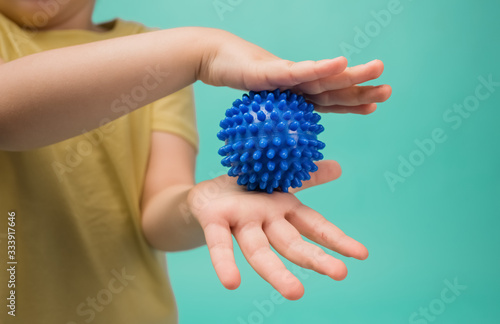 Girl holds blue sports ball in her hands