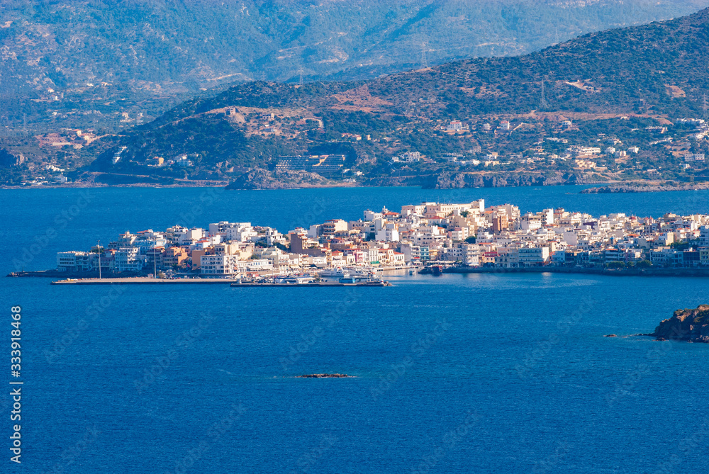 Aerial view of the jutting village of Agios Nikolaos in the sea on Crete, Greece, Europe
