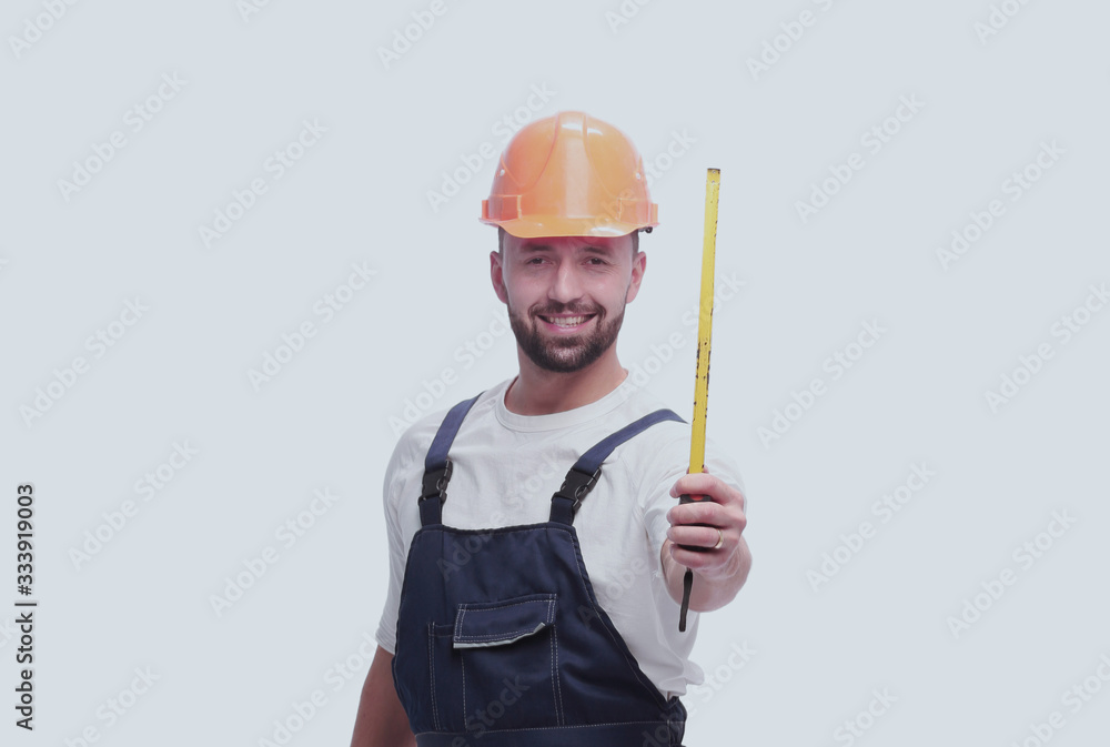 in full growth. man Builder with construction tape measure in full growth. man Builder with construction tape measure