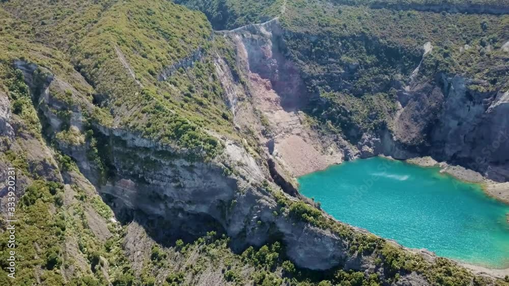 Costa Ricas Irazu Volcano close to San Jose aerial/drone, showing crater, blue lake, clouds and crater edge Costa Ricas Irazu Volcano close to San Jose aerial/drone, showing crater, blue lake, clouds and crater edge
