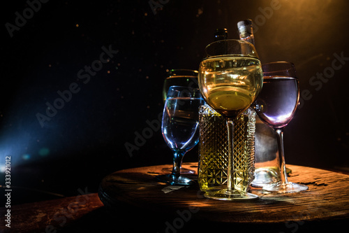 Goblet of white wine on wooden table on wooden wall background