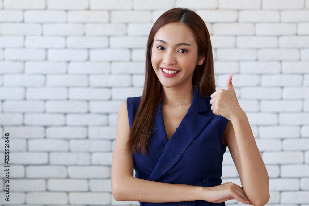 Young happy beauty Asian woman showing thumbs up, good job, excellent position. Young happy beauty Asian woman showing thumbs up, good job, excellent position.