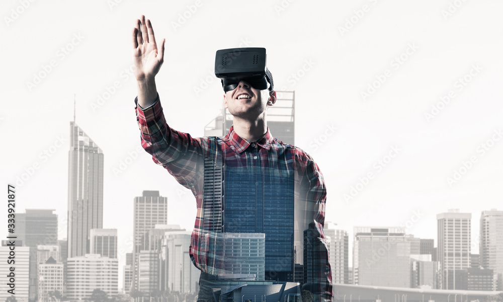 Guy wearing checked shirt and virtual mask stretching hand to touch something Guy wearing checked shirt and virtual mask stretching hand to touch something