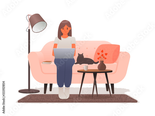 Work at home. A woman sitting on a sofa works at a laptop. Freelance during an outbreak of coronavirus. Quarantine