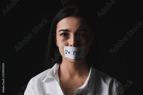Scared female victim with t...