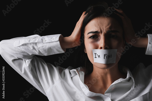 Scared female victim with t...