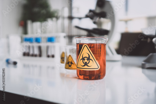 Yellow Biohazzard sign on Chemical Glassware in Lab photo