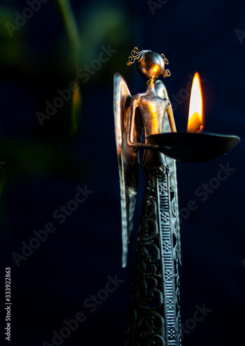 Metallic angel holding a flame of hope