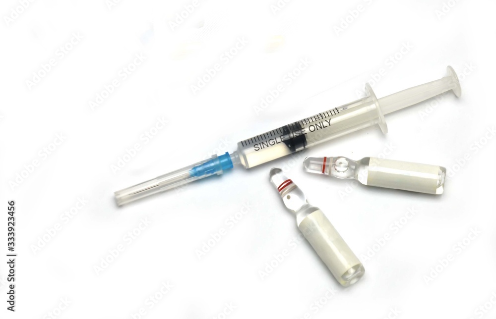 medical syringe and ampoules with medicine on a white medical syringe and ampoules with medicine on a white
