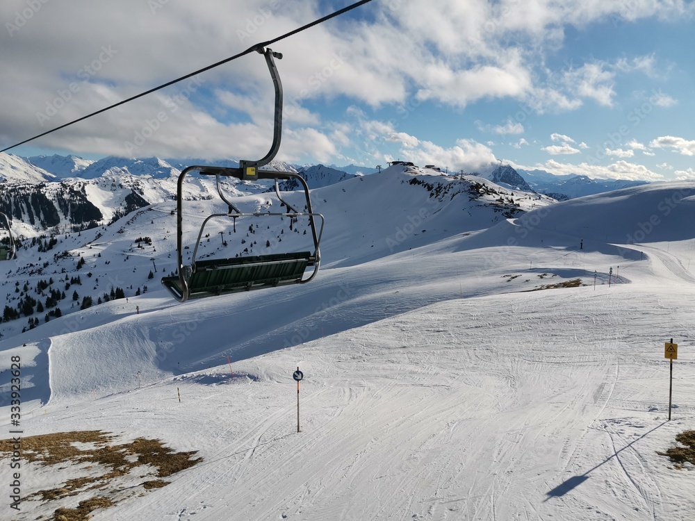 chairlift closeup in a ski resort above ski slopes during sunset, no people, kitzbuehel chairlift closeup in a ski resort above ski slopes during sunset, no people, kitzbuehel