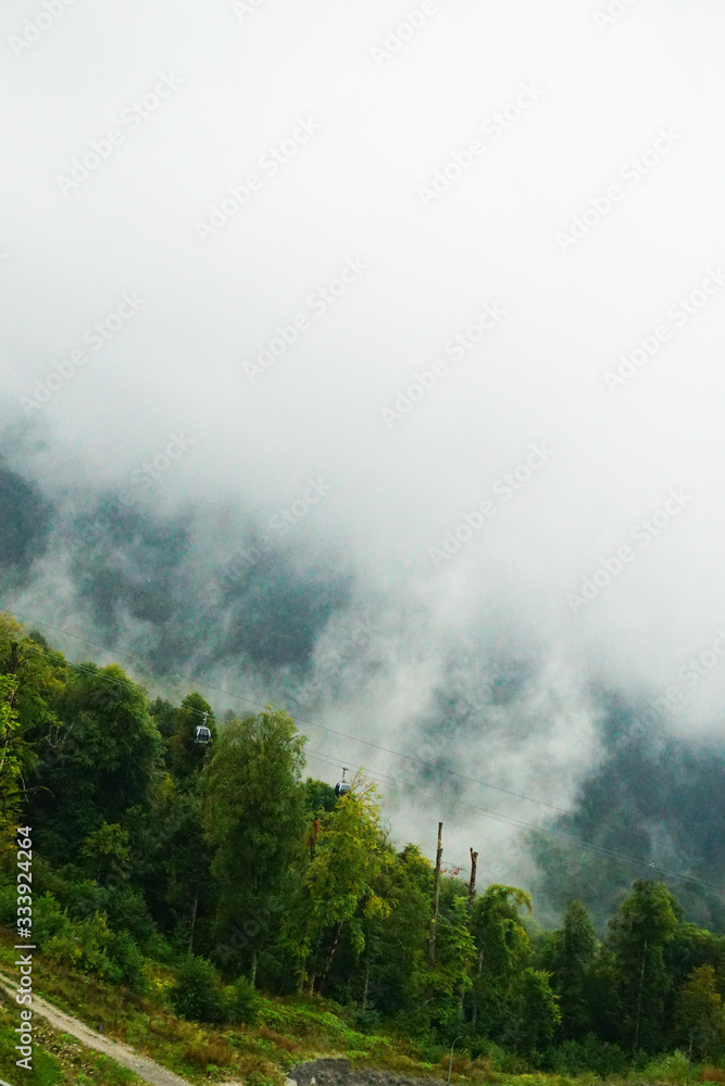 white clouds in the mountains of Rosa Khutor on a summer day in Sochi