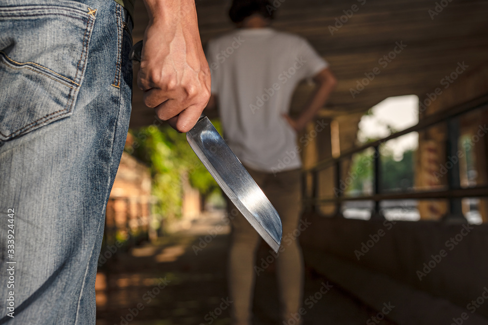 The image of a man being attacked by a knife using his knife.