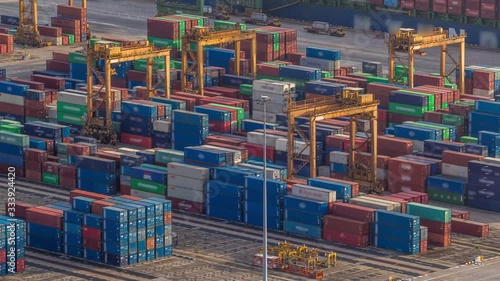Wallpaper Mural Commercial port of Singapore aerial timelapse. Bird eye close up view to loaders of busiest Asian cargo port with hundreds of ships loading export and import goods and thousands of containers in Torontodigital.ca