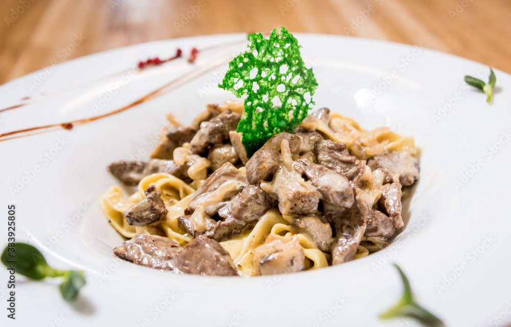 Pasta with meat in pan. Italian style cuisine. Restaurant.