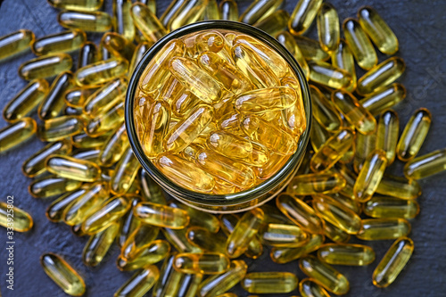 A close up of Omega-3 capsules in a glass jar