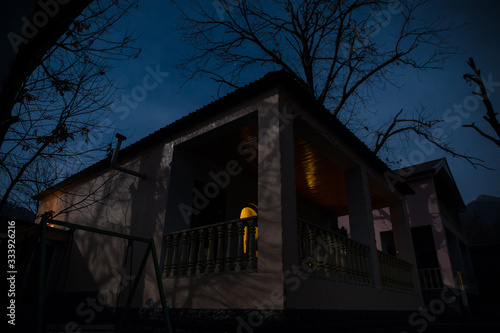 Full moon over quiet village at night. Beautiful night landscape of old town street with lights