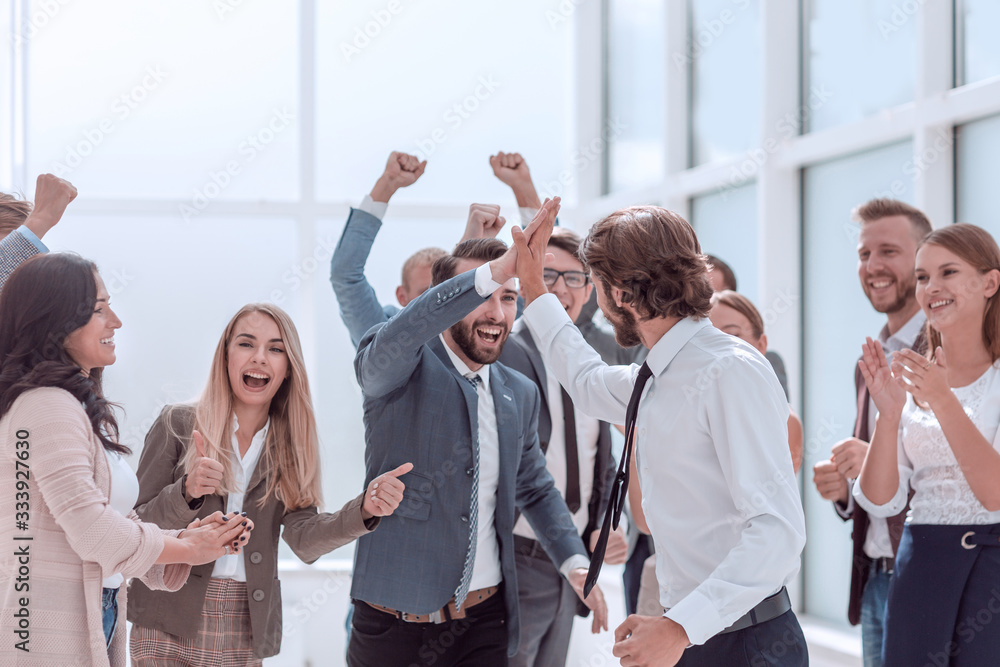 © ASDF - corporate group of employees congratulating each other on the victory © ASDF - corporate group of employees congratulating each other on the victory