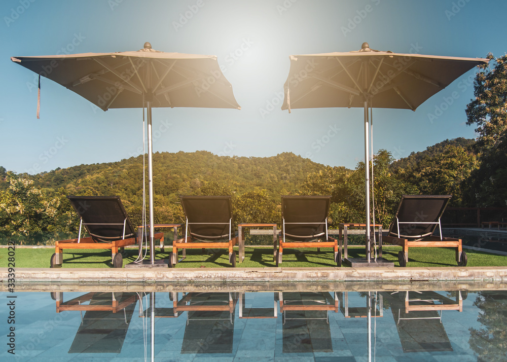 Fototapeta premium Pool chairs beside the pool