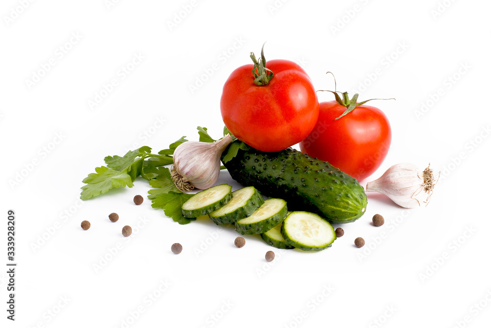 Red tomato garlic and cucumber on a white background.Fresh vegetables on a white background. cucumber and tomato on a white background Red tomato garlic and cucumber on a white background.Fresh vegetables on a white background. cucumber and tomato on a white background