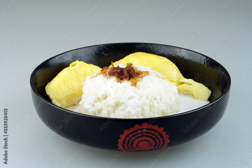 'Pulut Durian' is a glutinous or sticky rice with durian, coconut milk and sprinkle of grated palm sugar-selective focus 'Pulut Durian' is a glutinous or sticky rice with durian, coconut milk and sprinkle of grated palm sugar-selective focus