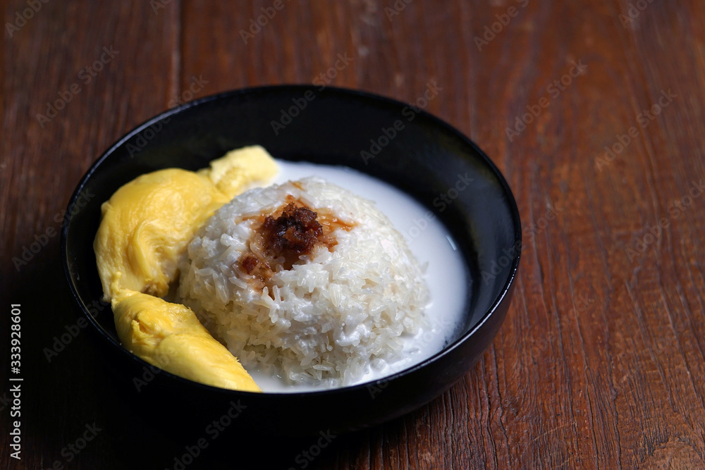 'Pulut Durian' is a glutinous or sticky rice with durian, coconut milk and sprinkle of grated palm sugar-selective focus