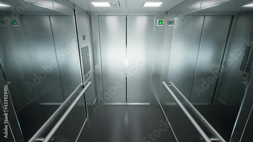 Empty, modern elevator with brushed steel walls traveling upwards in a loop 4KHD photo