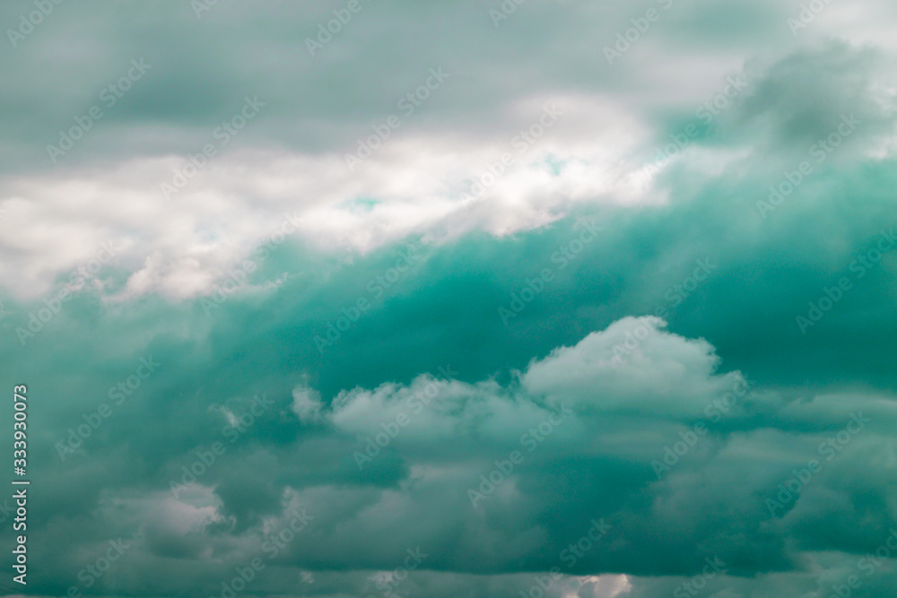 Toned in mint color clouds close-up. Dark gray clouds on a rainy day. Natural background. Toned in mint color clouds close-up. Dark gray clouds on a rainy day. Natural background.