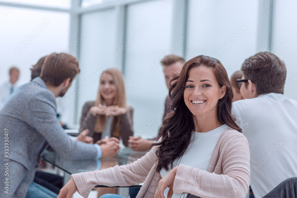 successful business woman sitting in front of a table in a conference room.