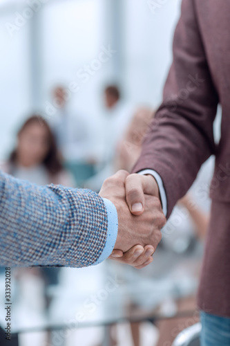 close up. handshake of business men on the office background