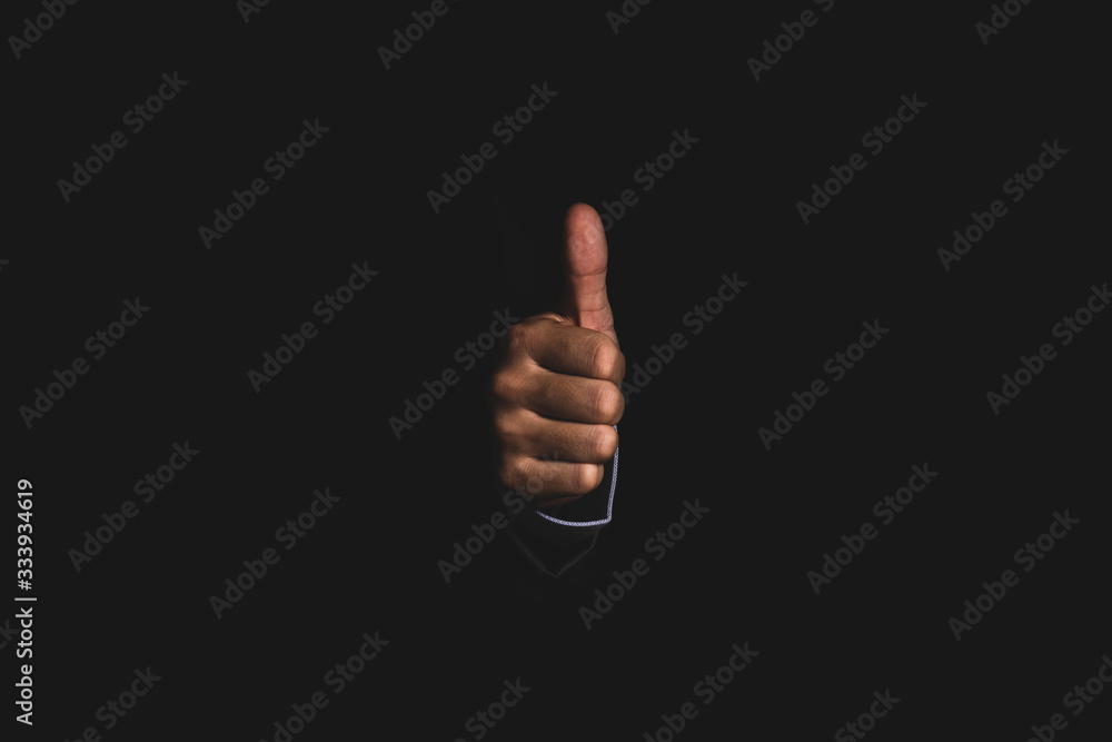 Businessman hand thumb up or like to good signal on black background. Businessman hand thumb up or like to good signal on black background.