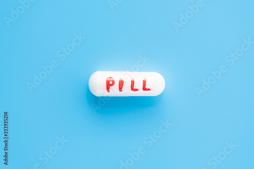 white pill on a blue background. a cure for everything.