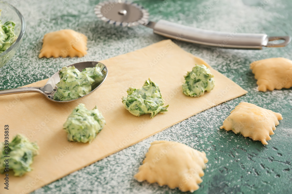 Fototapeta premium Preparing of tasty ravioli on color background