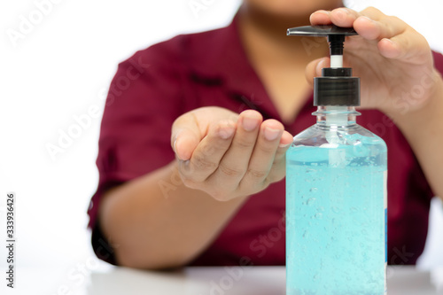 Women's hands use sanitizing gel to wash hands. In a pump bottle to kill bacteria and viruses.