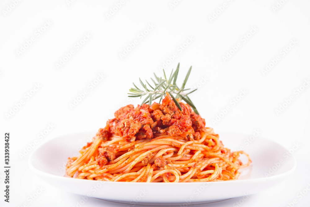 Spaghetti bolognese on a plate decorated with a rosemary twig Spaghetti bolognese on a plate decorated with a rosemary twig