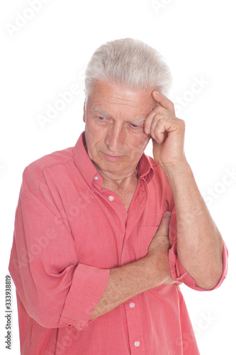 Portrait of sad senior man with headache isolated