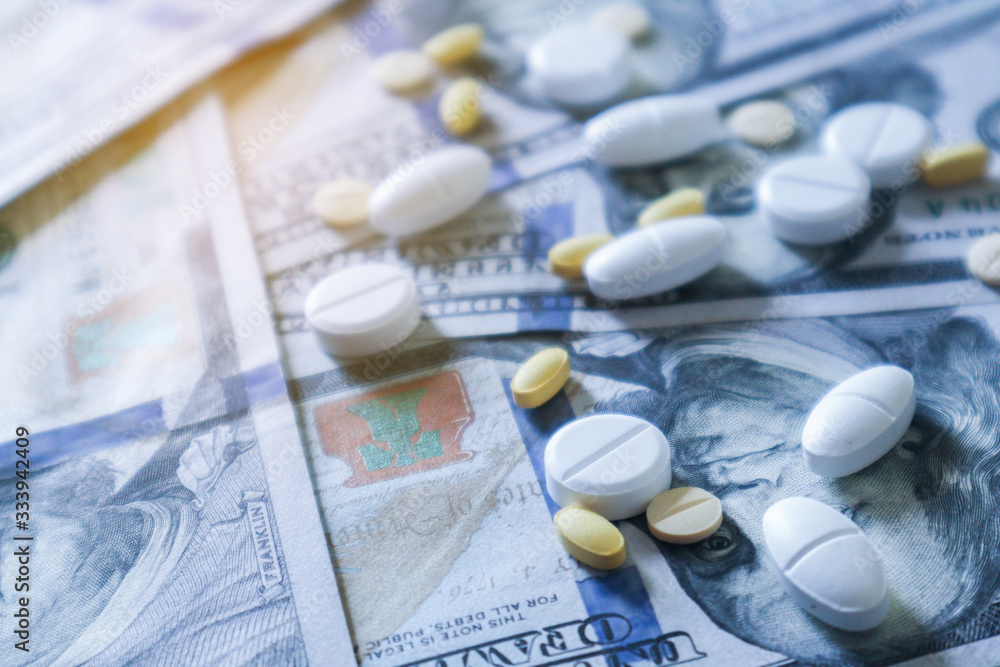 medicine pill on 100 dollar banknote background.Healthcare insurance and medical treatment cost concept medicine pill on 100 dollar banknote background.Healthcare insurance and medical treatment cost concept