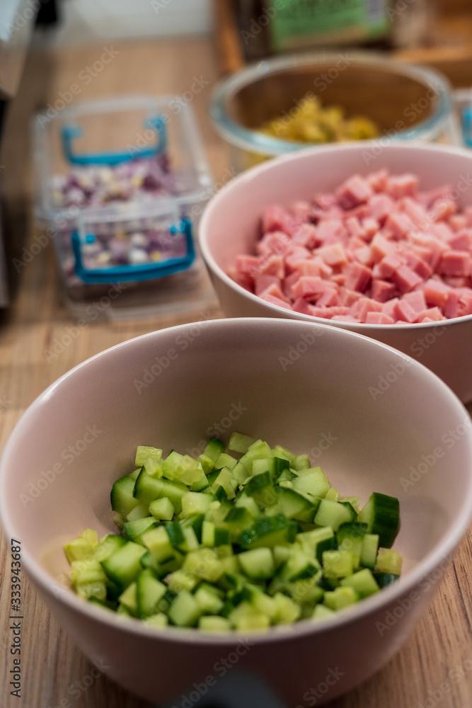 Diced cucumber and ham in pink bowls Diced cucumber and ham in pink bowls