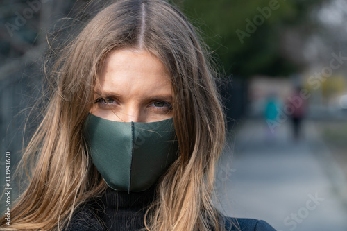 Protection from coronavirus covid-19. Young pretty woman in a protective mask
