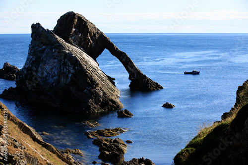 Portknockie (Scotland), UK - August 01, 2018: Bow Fiddle Rock sea arch, Portknockie, Scotland, Highlands, United Kingdom photo