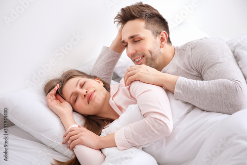Morning of young couple in bed