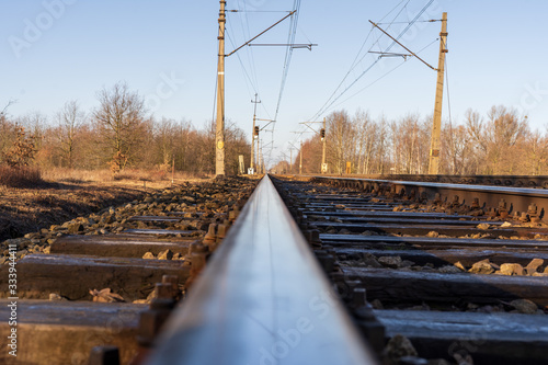 Railway with semaphore and electric poles.